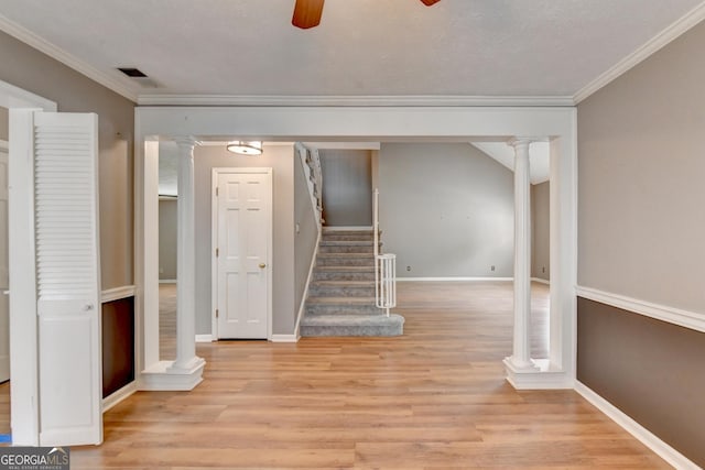 basement with ornamental molding, ceiling fan, and light wood-type flooring