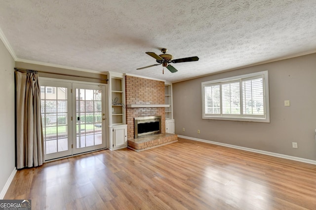 unfurnished living room featuring a textured ceiling, ceiling fan, light hardwood / wood-style floors, and a fireplace