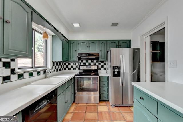 kitchen with appliances with stainless steel finishes, light tile patterned floors, green cabinetry, sink, and tasteful backsplash