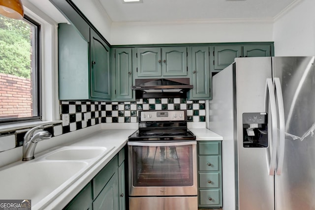 kitchen featuring stainless steel appliances, green cabinetry, backsplash, ornamental molding, and sink