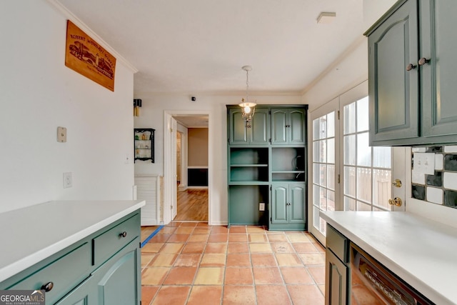 kitchen with green cabinetry, ornamental molding, light tile patterned floors, and hanging light fixtures