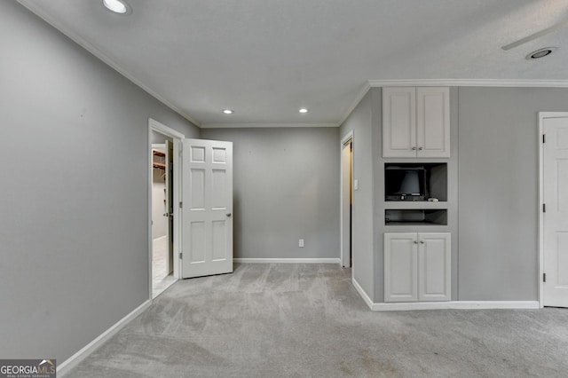 interior space with white cabinetry, light carpet, and crown molding