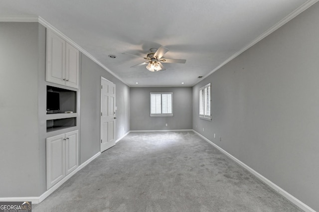 unfurnished living room with ceiling fan, ornamental molding, and light carpet