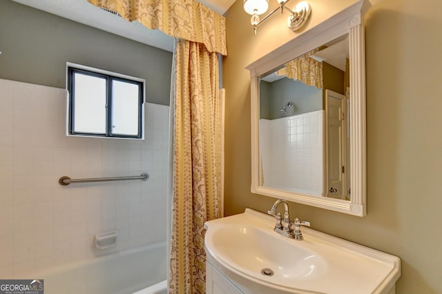 bathroom with shower / bath combo with shower curtain and sink