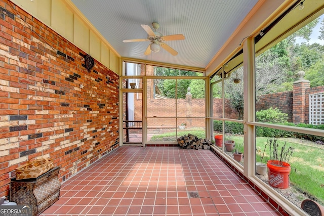 unfurnished sunroom with vaulted ceiling, ceiling fan, and a wealth of natural light