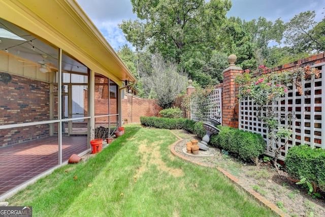 view of yard with ceiling fan