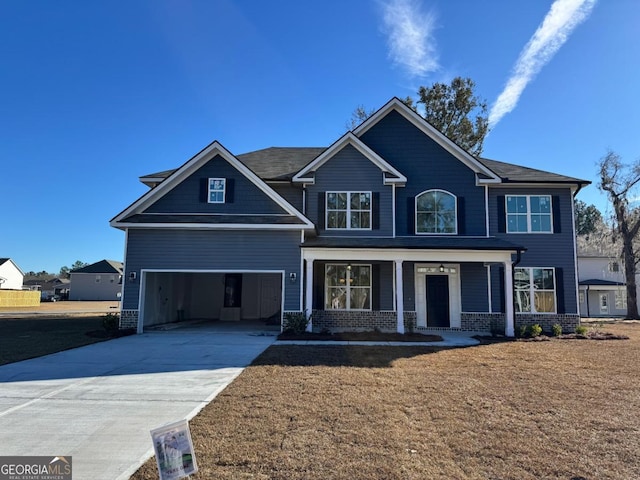 craftsman-style home featuring covered porch and a garage