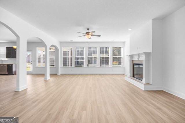 unfurnished living room with ceiling fan and carpet floors