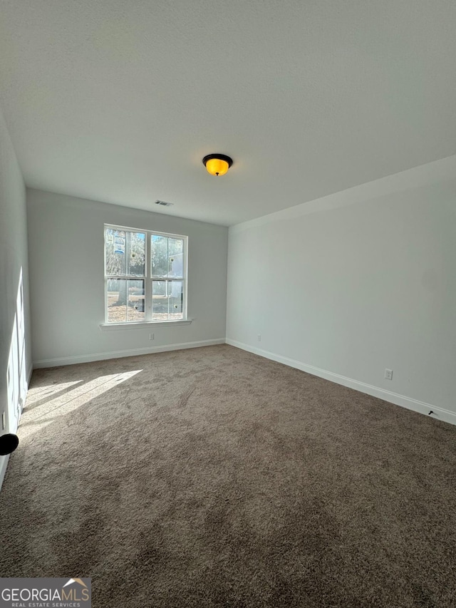 unfurnished room featuring carpet