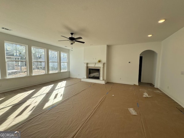 unfurnished living room with ceiling fan