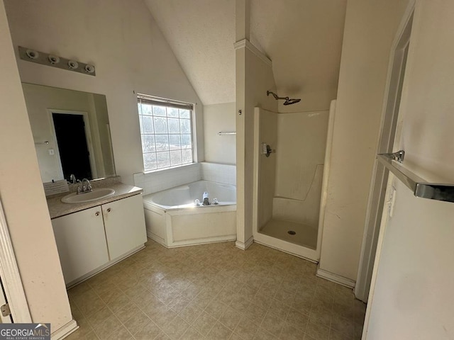 bathroom featuring a textured ceiling, separate shower and tub, lofted ceiling, and vanity