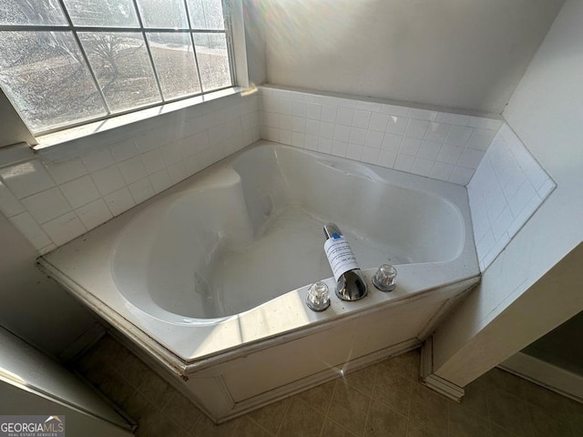 bathroom with a bathtub and tile patterned floors