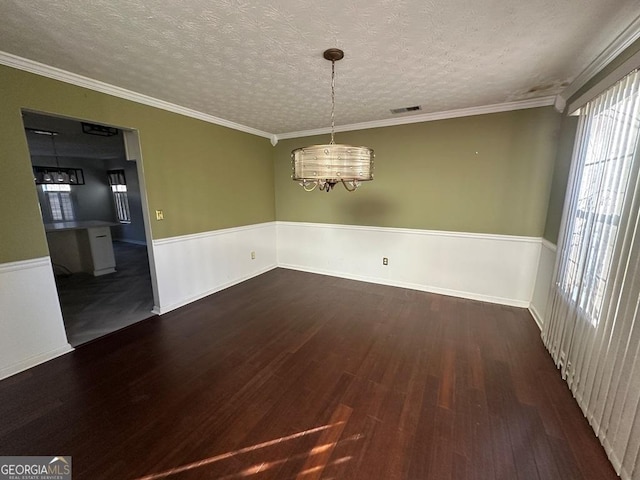 unfurnished dining area with a textured ceiling, crown molding, a chandelier, and dark hardwood / wood-style floors