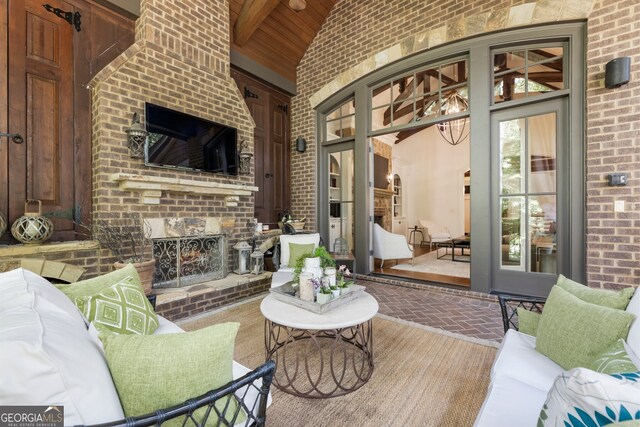 view of patio / terrace with an outdoor living space with a fireplace