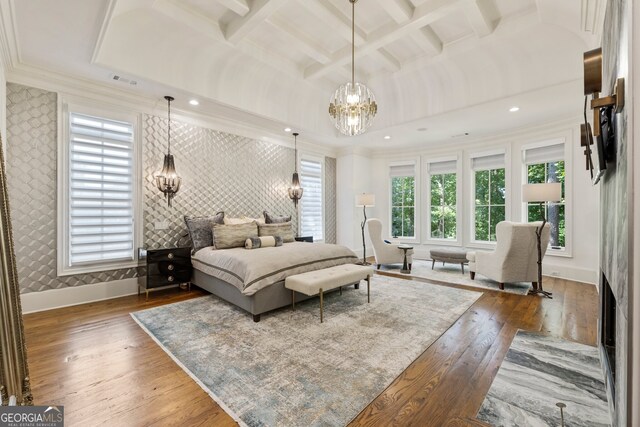 bedroom with a notable chandelier, coffered ceiling, dark hardwood / wood-style flooring, crown molding, and beam ceiling