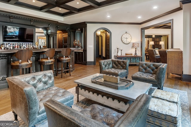 4874 Kettle River Pt, Suwanee, GA 30024 - living room featuring beamed ceiling, wood finished floors, arched walkways, and ornamental molding