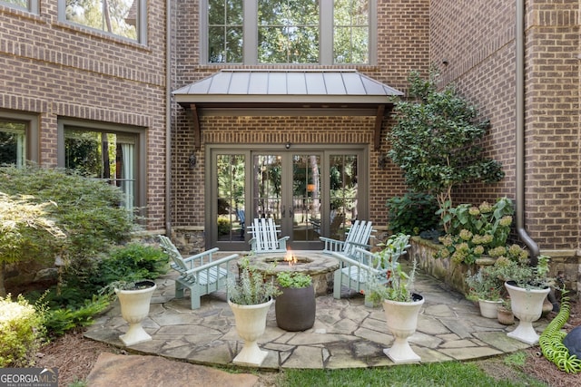4874 Kettle River Pt, Suwanee, GA 30024 - view of patio featuring french doors and an outdoor fire pit