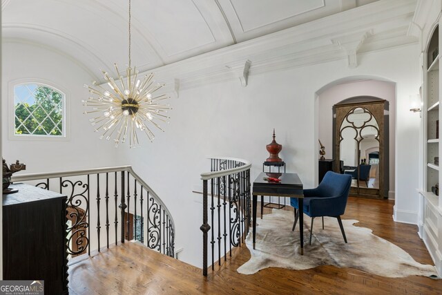 hall with hardwood / wood-style floors, a notable chandelier, and beam ceiling