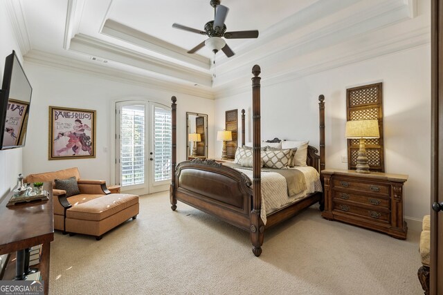 carpeted bedroom featuring french doors, ceiling fan, a tray ceiling, ornamental molding, and access to exterior