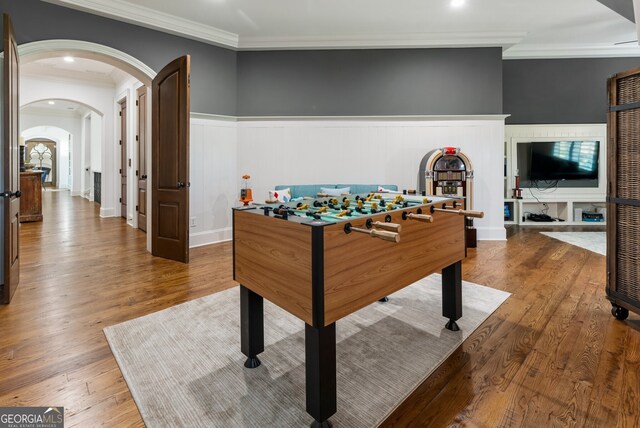 playroom with ornamental molding and hardwood / wood-style flooring