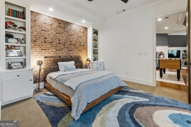 carpeted bedroom with ornamental molding and ceiling fan