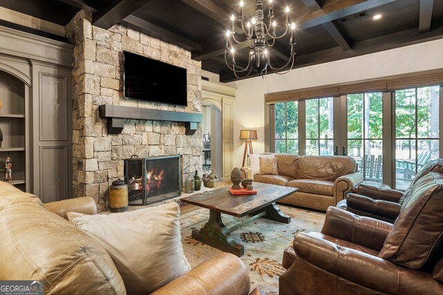 living room featuring built in features, a fireplace, beam ceiling, and a notable chandelier