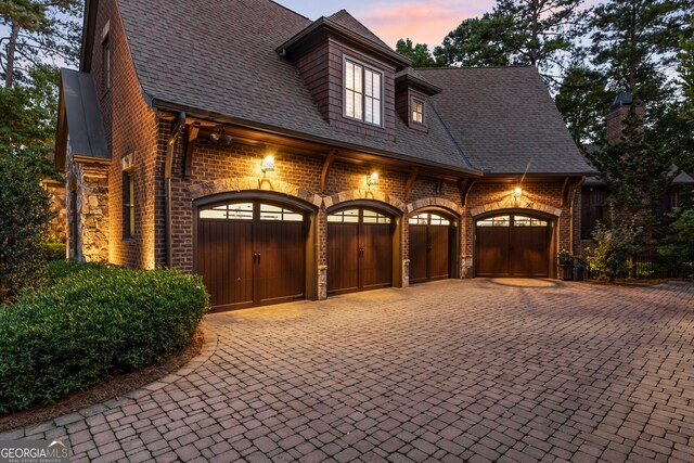 view of garage at dusk