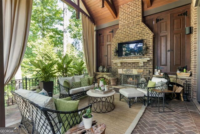 view of patio / terrace with an outdoor living space with a fireplace