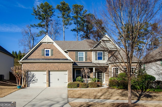 view of front of home featuring a garage and central AC