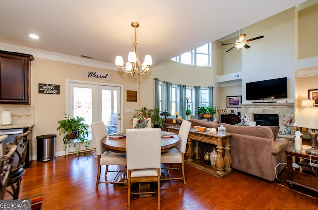 dining space with ornamental molding, dark hardwood / wood-style floors, and ceiling fan with notable chandelier