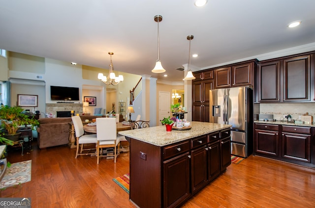 kitchen with an inviting chandelier, stainless steel fridge with ice dispenser, dark brown cabinets, and hanging light fixtures