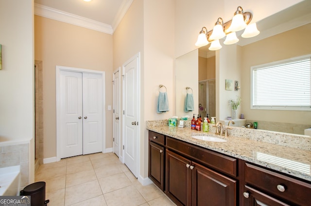 bathroom with tile patterned flooring, a shower with door, crown molding, and vanity