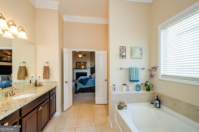 bathroom with vanity, tile patterned floors, ornamental molding, ceiling fan, and a bathing tub