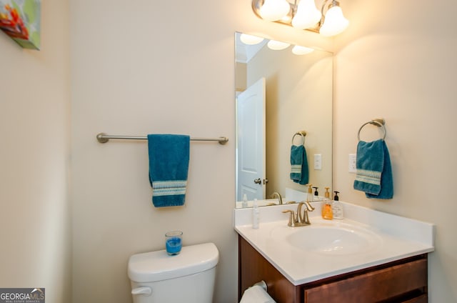 bathroom featuring toilet and vanity