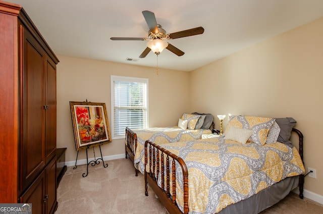 bedroom featuring ceiling fan and light carpet