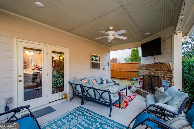 view of patio / terrace with french doors, ceiling fan, and an outdoor living space with a fireplace