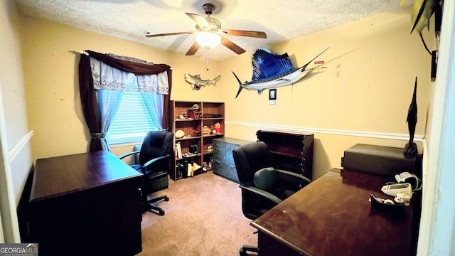 office area featuring a textured ceiling, ceiling fan, and light colored carpet