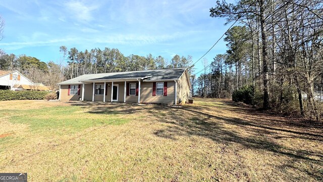 single story home with a front yard and covered porch