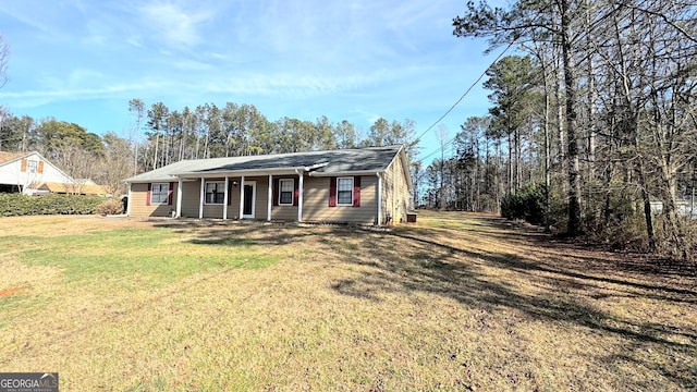 ranch-style house featuring a porch and a front yard