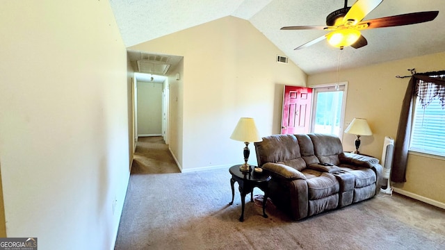 carpeted living room featuring ceiling fan, vaulted ceiling, and a textured ceiling