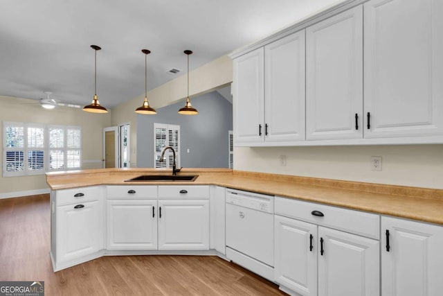 kitchen with sink, white cabinetry, kitchen peninsula, white dishwasher, and hanging light fixtures