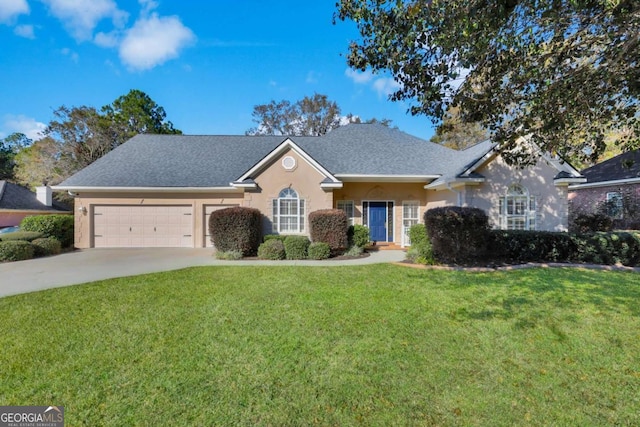 view of front of house featuring a front yard and a garage