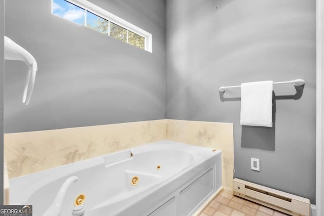 bathroom with a washtub and a baseboard heating unit