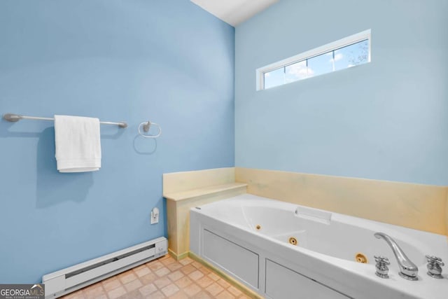 bathroom with a tub and a baseboard heating unit