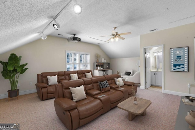 living room featuring a textured ceiling, ceiling fan, vaulted ceiling, and light colored carpet