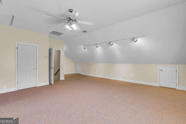 additional living space with ceiling fan, light carpet, and lofted ceiling