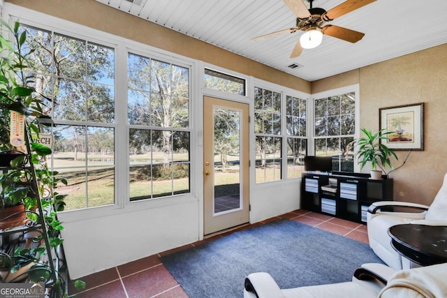 sunroom / solarium featuring ceiling fan