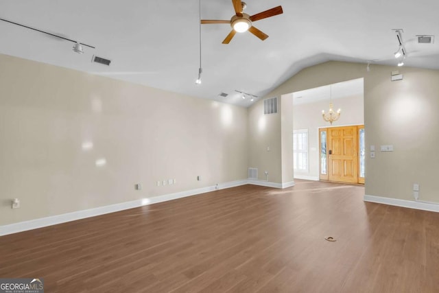 unfurnished living room with track lighting, vaulted ceiling, ceiling fan with notable chandelier, and wood-type flooring