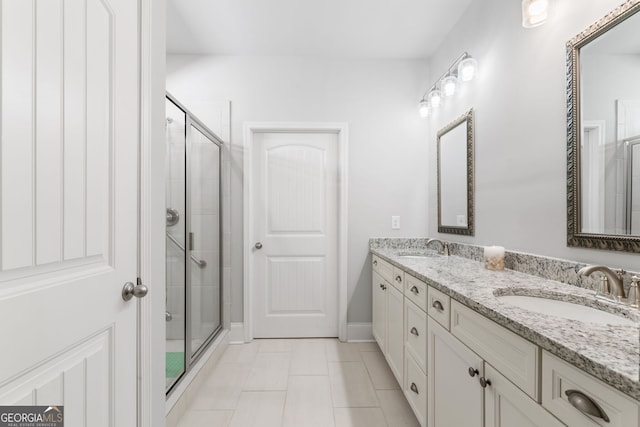 bathroom featuring vanity, walk in shower, and tile patterned flooring