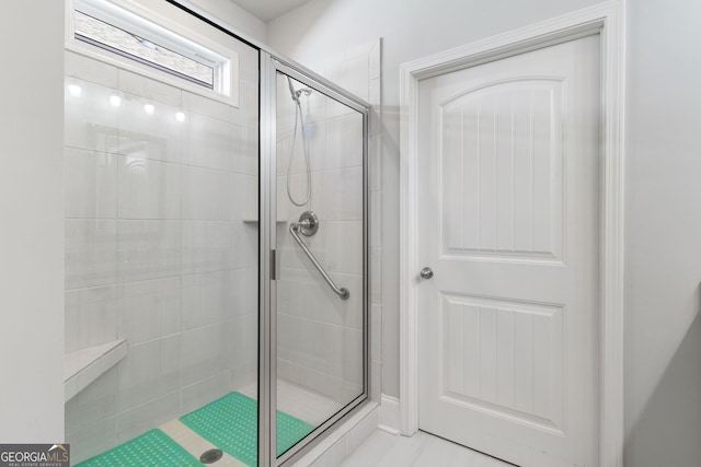 bathroom with tile patterned flooring and an enclosed shower